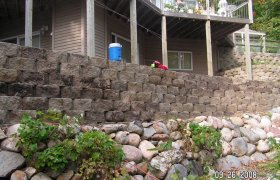 Block retaining wall designed and installed by Exterior Designs of Alexandria