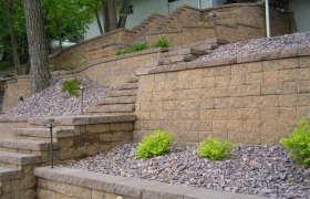 Block retaining wall designed and installed by Exterior Designs of Alexandria
