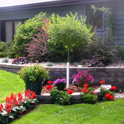 Home landscape with flower gardens and newly planted trees and shrubs