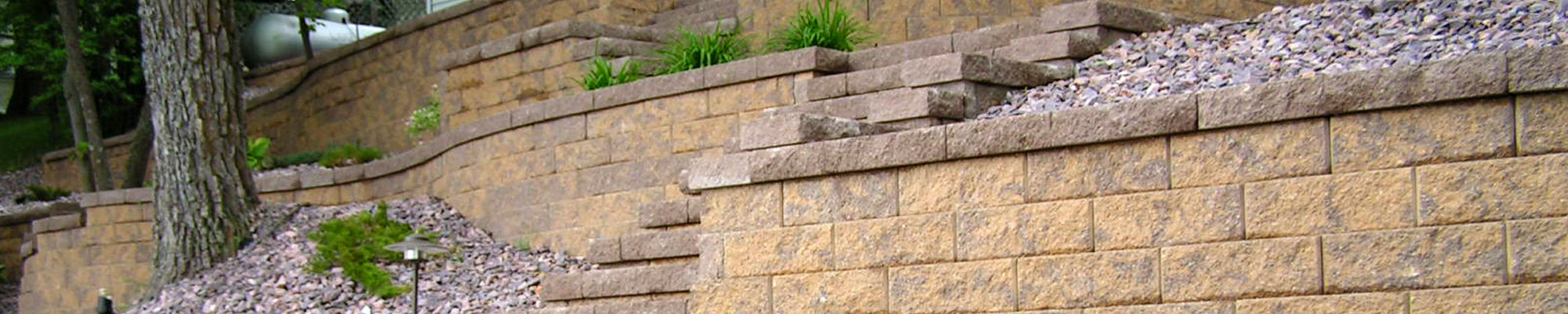 Multi-tiered block retaining wall designed and installed by Exterior Designs of Alexandria